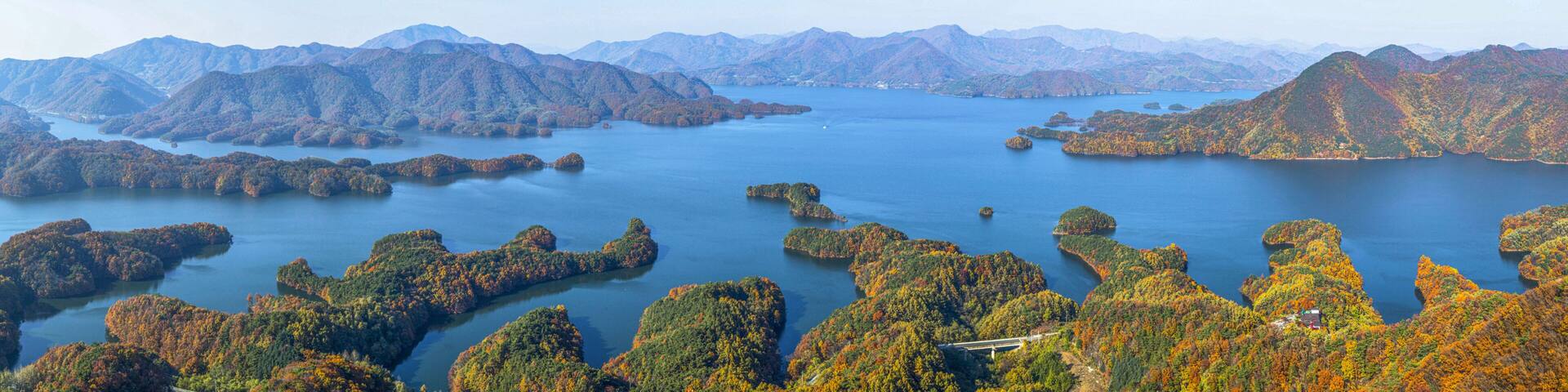 High angle and autumnal view of early maple at Crocodile Island of Chungjuho Lake at Salmi-myeon near Chungju-si, South Korea