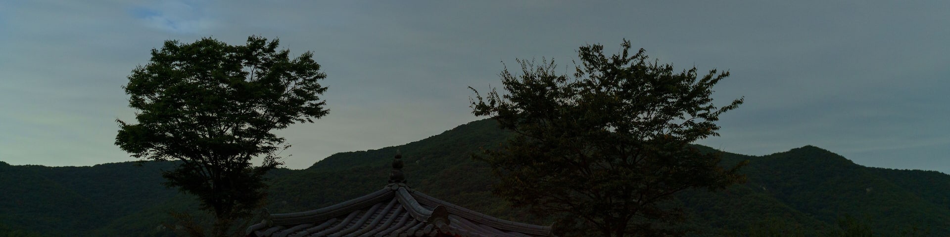Red light glows from a tent in a gazebo