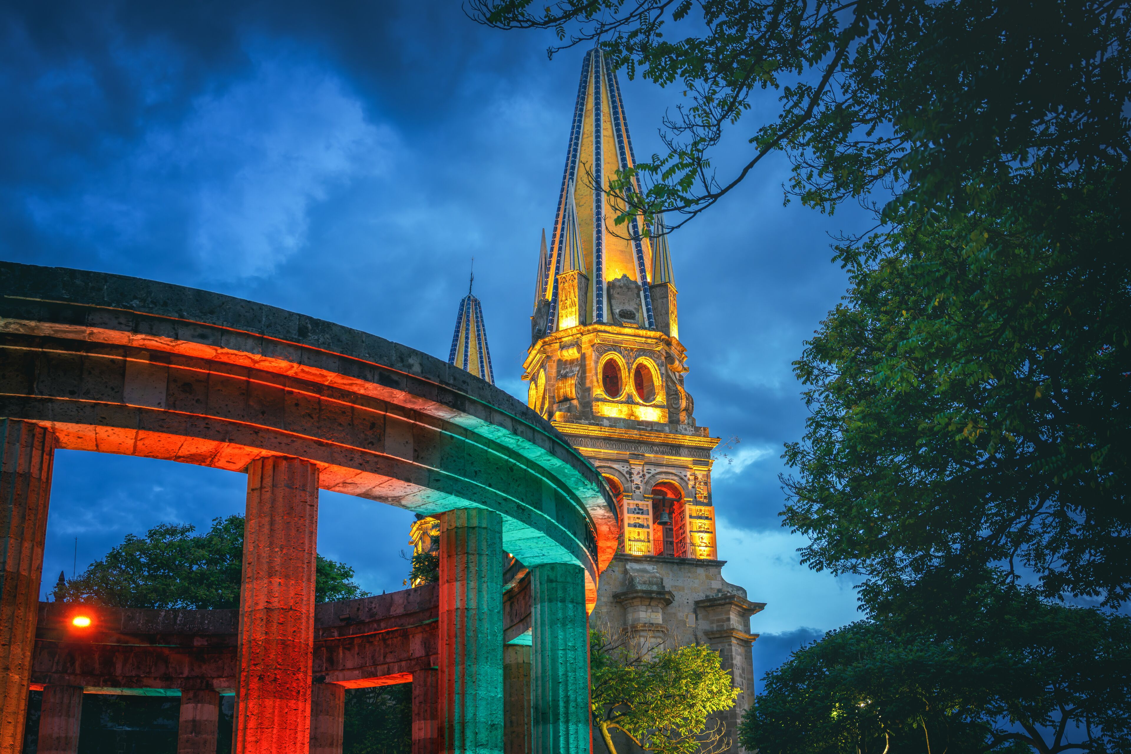 Rotonda de los Jaliscienses Ilustres and Guadalajara Cathedral Illuminated at night - Guadalajara, Jalisco, Mexico