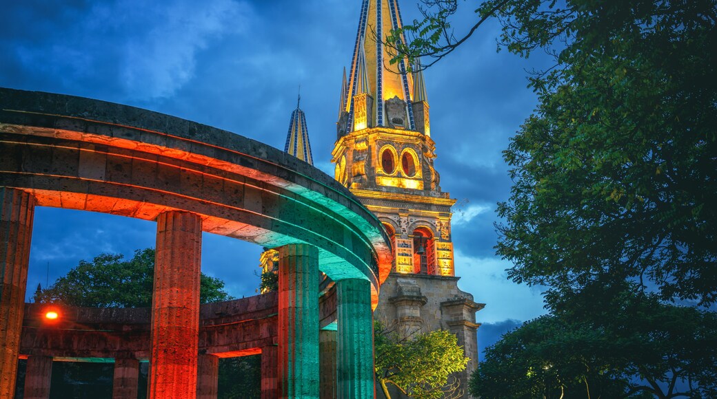 Rotonda de los Jaliscienses Ilustres and Guadalajara Cathedral Illuminated at night - Guadalajara, Jalisco, Mexico