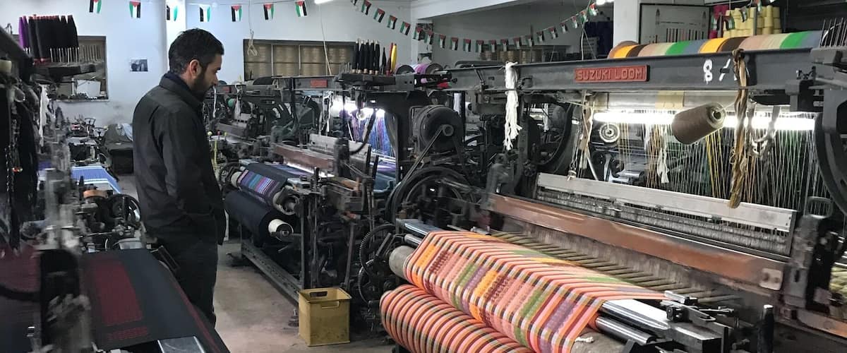 A textile factory with machinery and a worker.