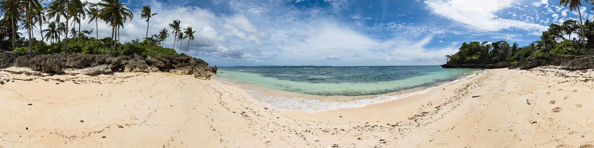 Tropical beach with coconut trees and waves on sand. Carabao Island in Romblon, Philippines. VR 360.