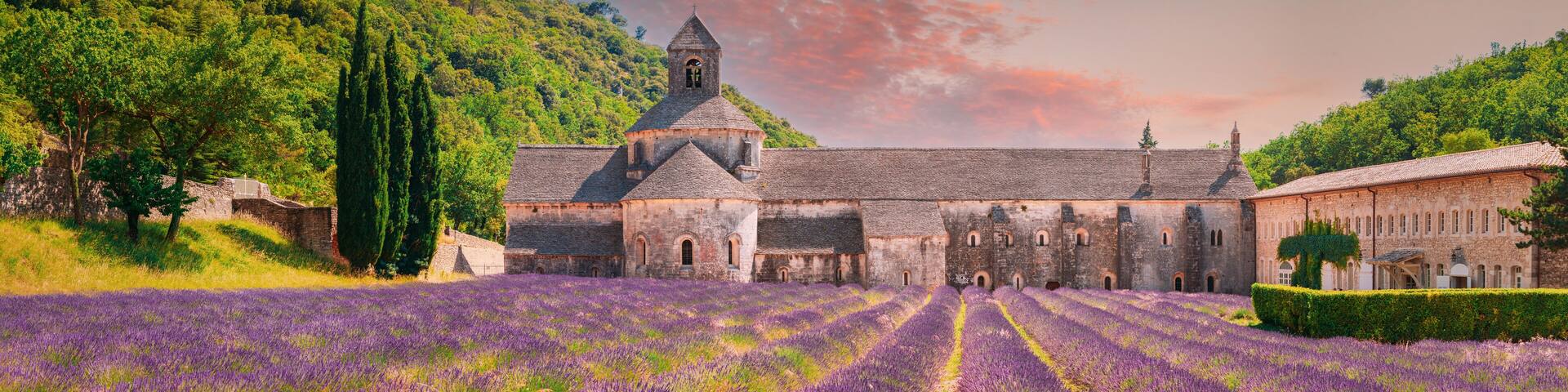 Notre-dame De Senanque Abbey, Vaucluse, France. Beautiful Landscape Lavender Field And An Ancient Monastery Abbaye Notre-dame De Senanque. Elevated View, Panorama. Altered Sunset Sky
