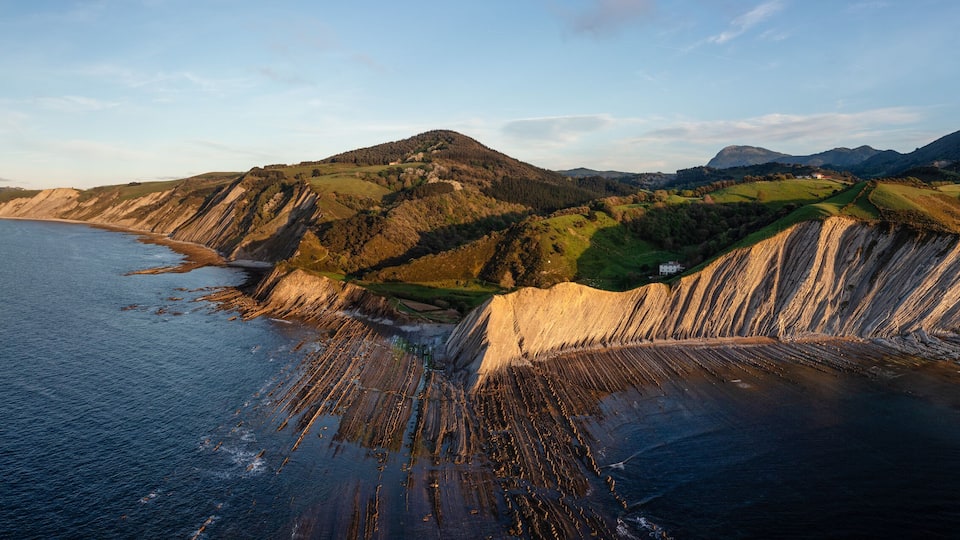 A coastal landscape with cliffs and a beach.