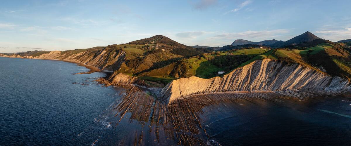 A coastal landscape with cliffs and a beach.