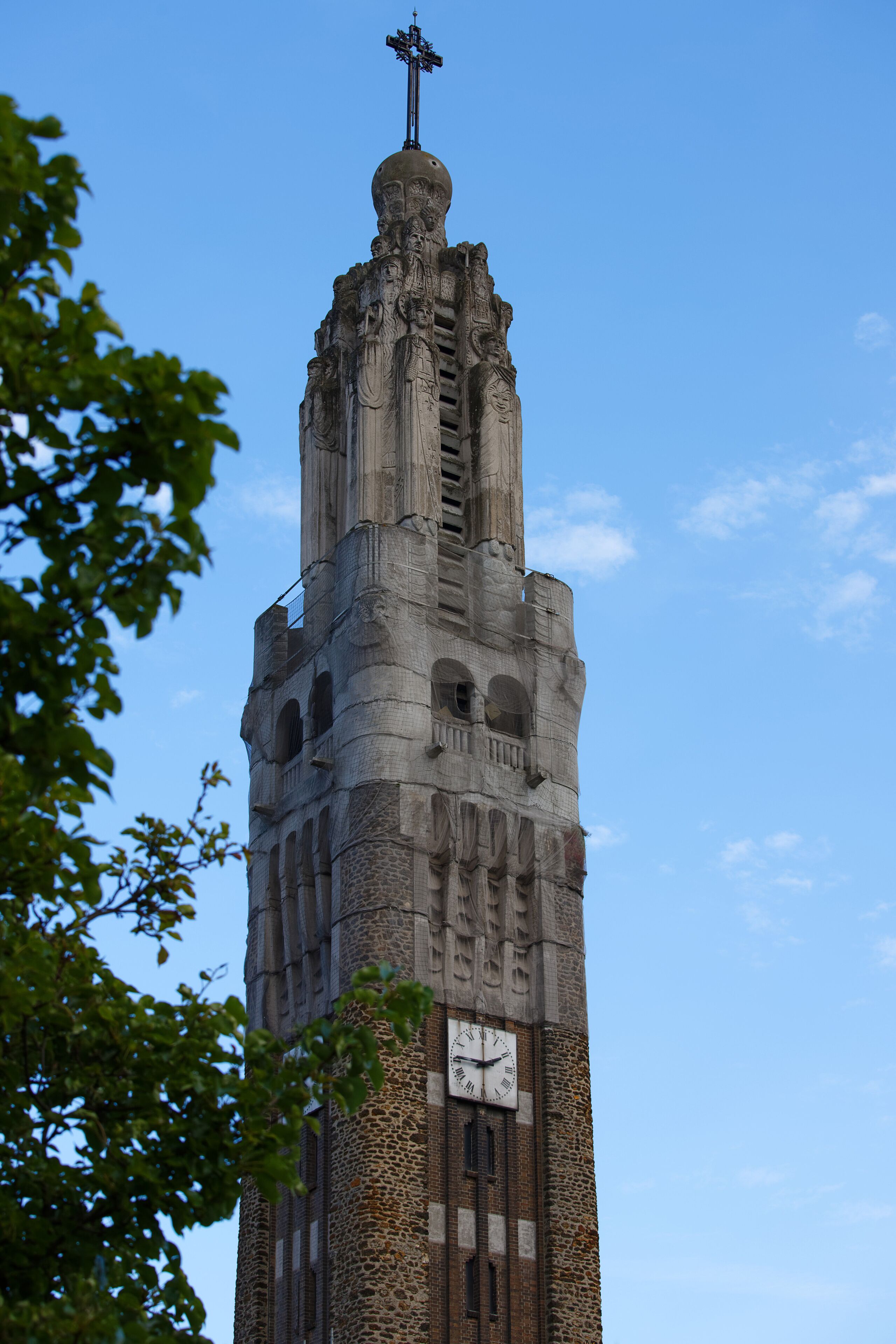 A tall tower with a clock and a weather vane.