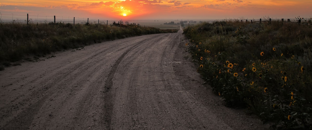 Dirt road at sunrise, North Platte River valley, western Nebraska, USA