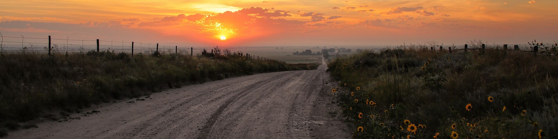Dirt road at sunrise, North Platte River valley, western Nebraska, USA