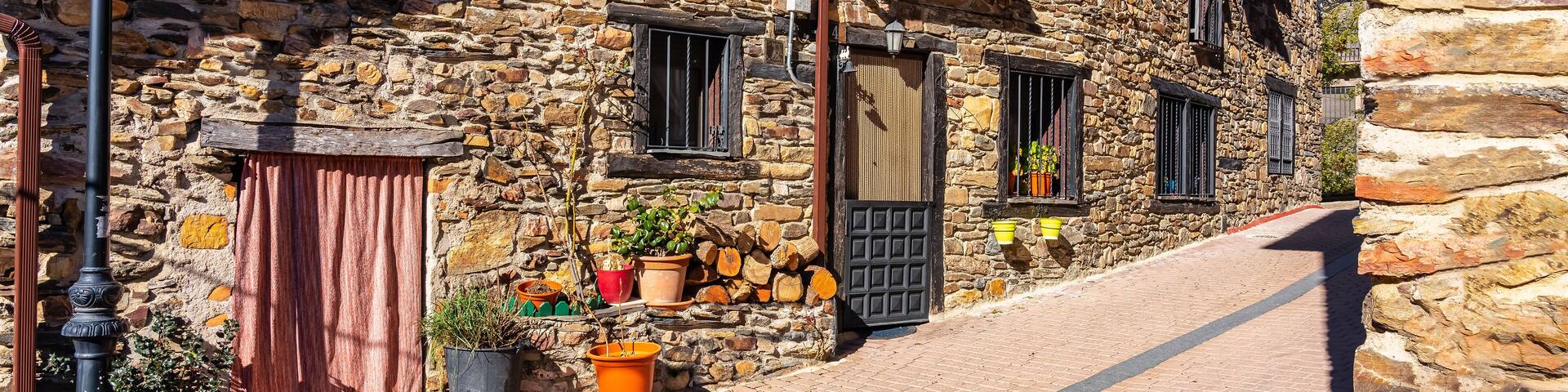 Picturesque houses with stone facades, wooden doors and windows in the mountain of Madrid, Puebla de la Sierra.