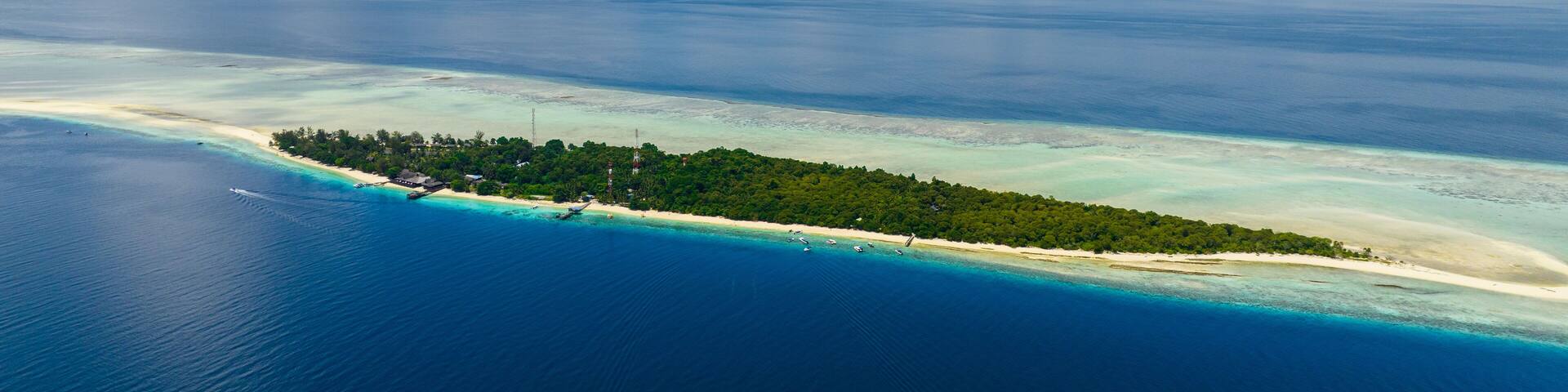 Aerial view of Mataking island on a coral reef or atoll with a sandy beach. Tropical landscape.Tun Sakaran Marine Park. Borneo, Sabah, Malaysia.