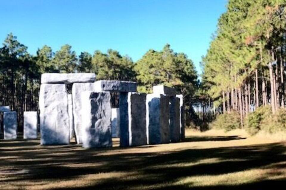 Stonehenge-like structures in a forest.