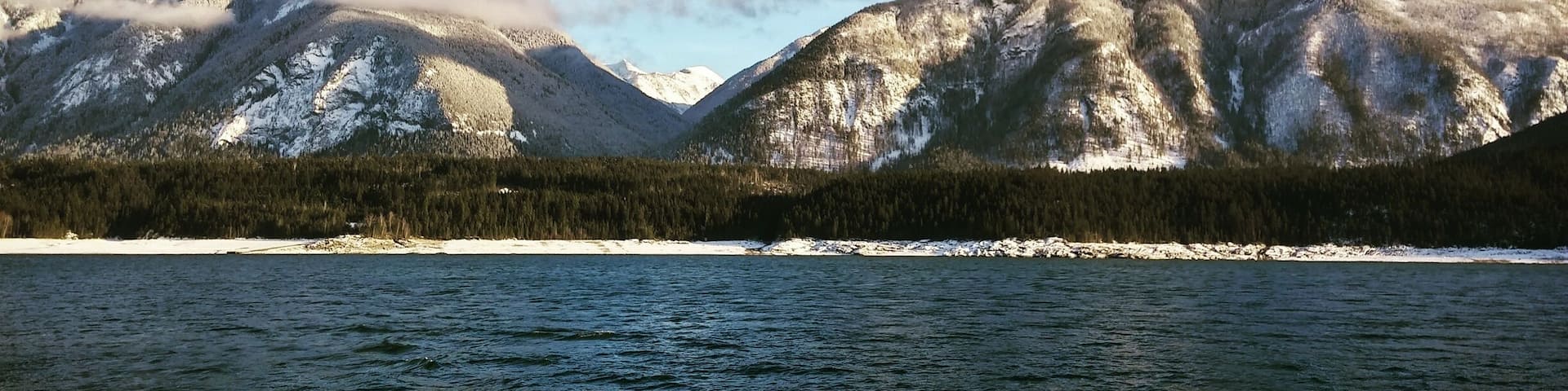 A lake with mountains in the background.