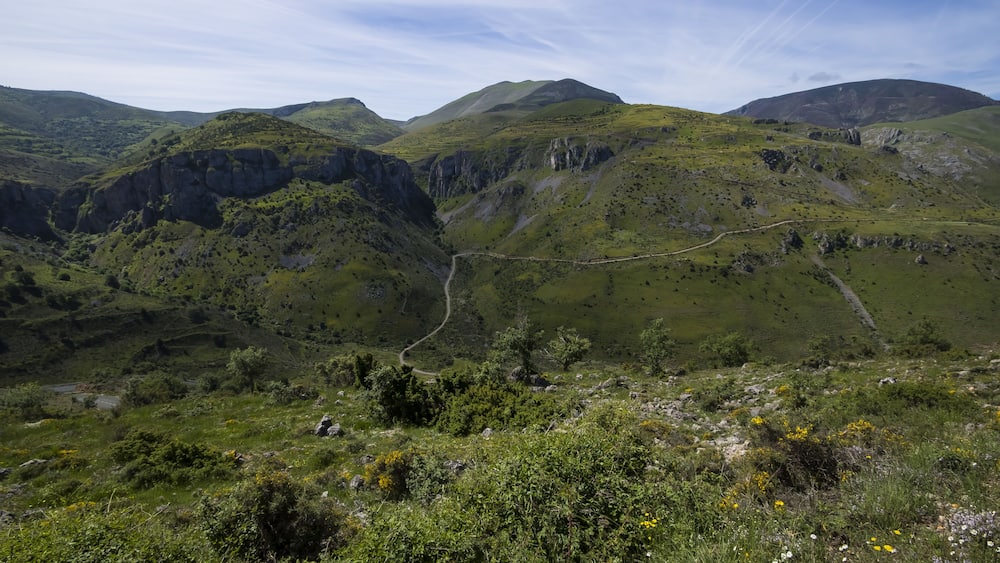 Eine gebirgige Landschaft mit einem Serpentinenweg.