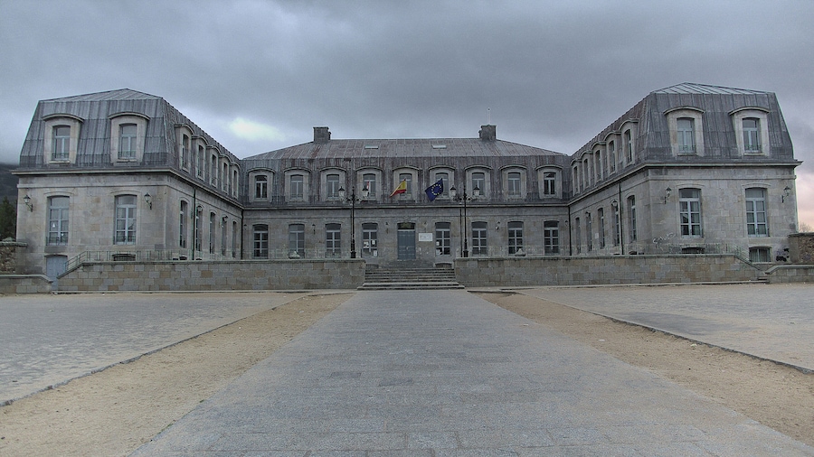 A large, historic building with symmetrical architecture, featuring a central entrance and multiple windows.