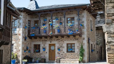 A stone building with wooden balconies and flower boxes.