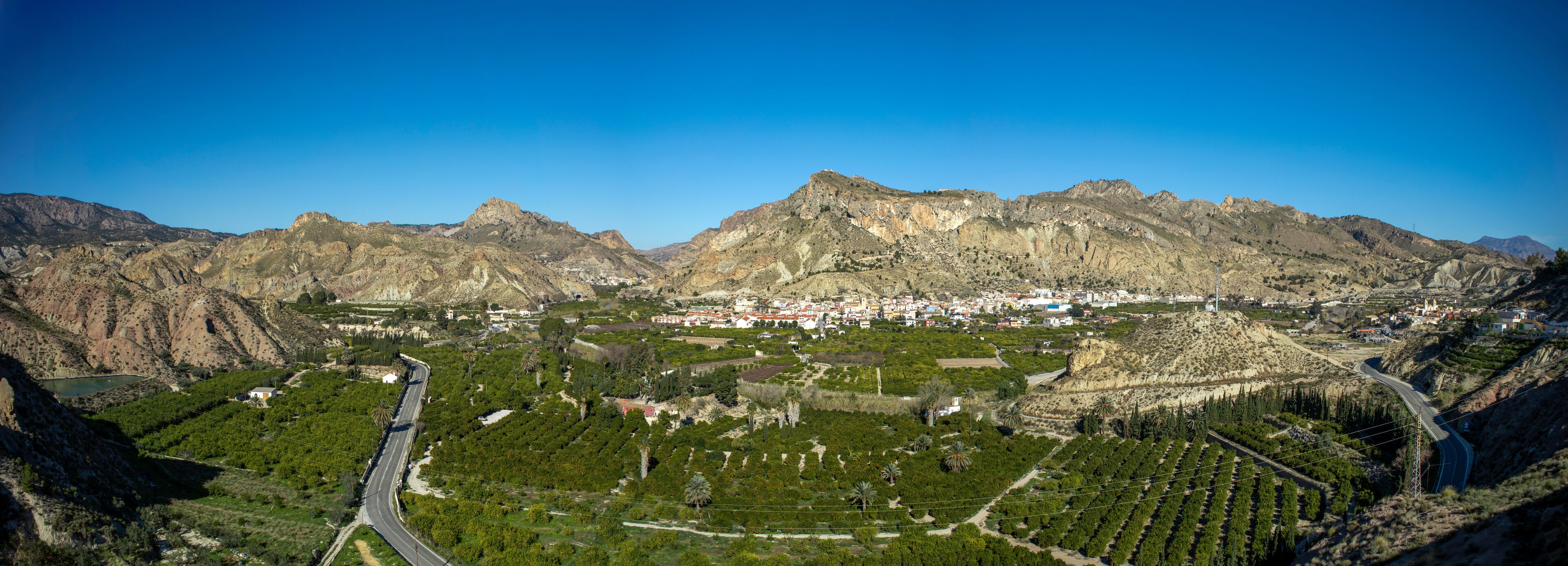A mountainous landscape with a town nestled in the valley.