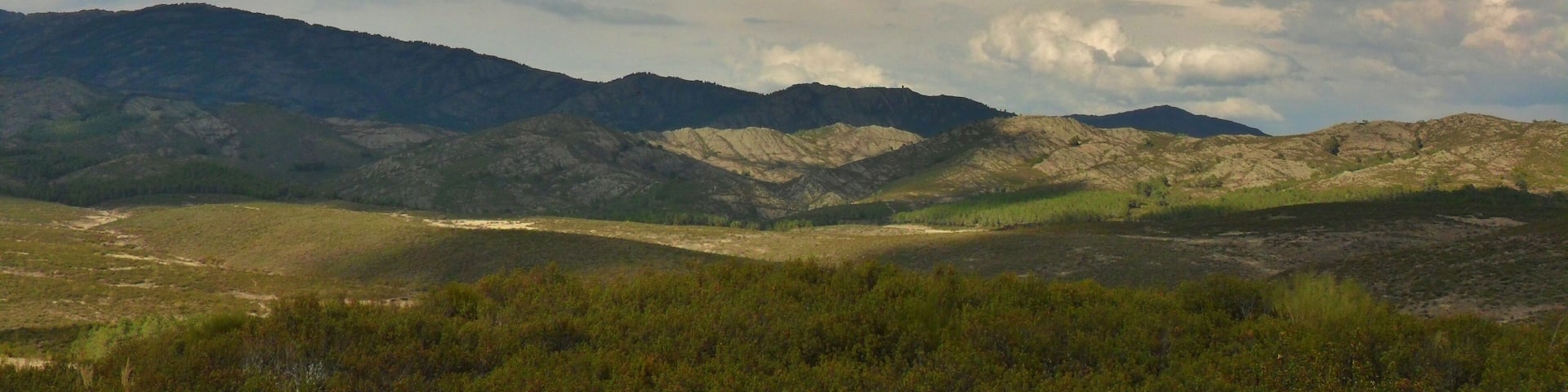 A mountainous landscape with rolling hills and a valley.