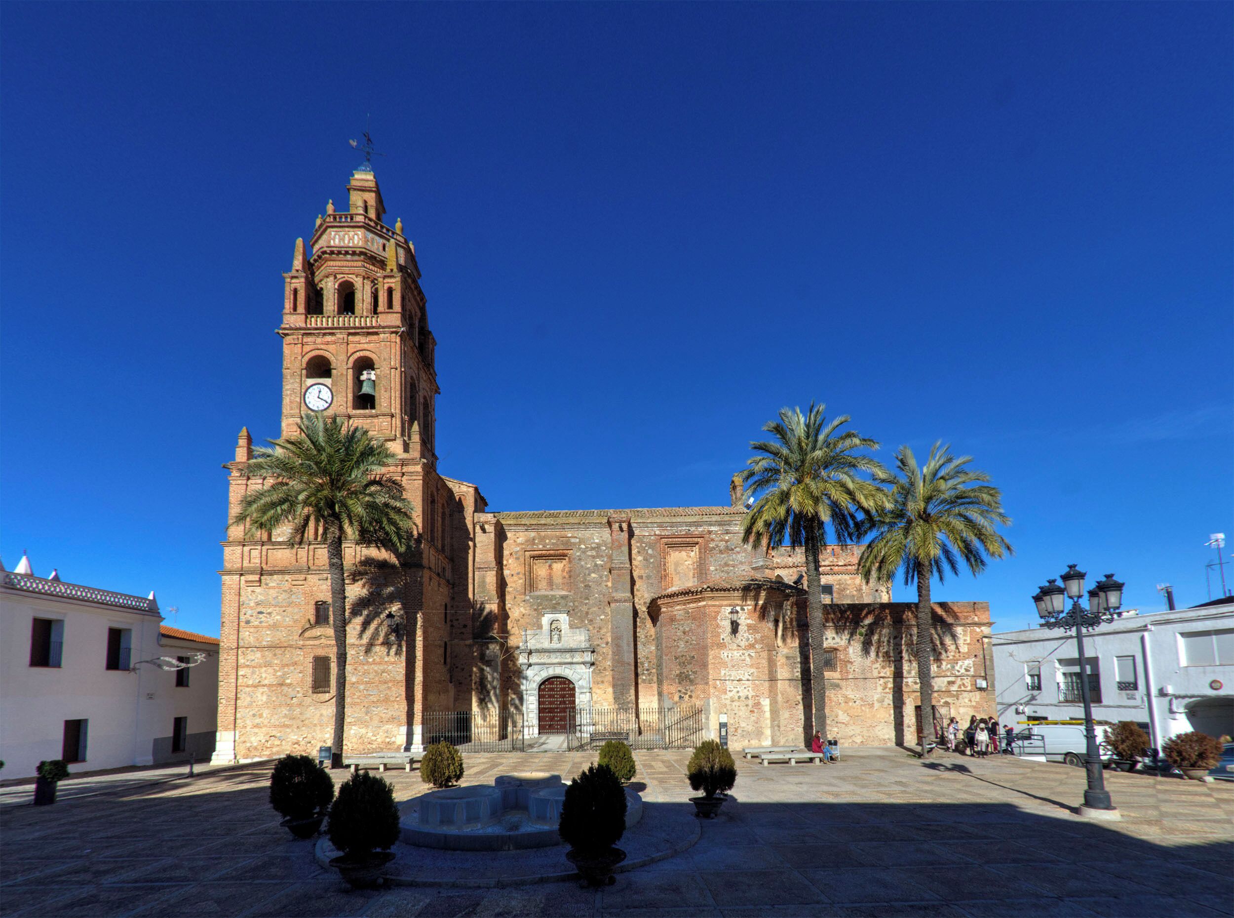 A historic church with a tall bell tower and a clear blue sky.