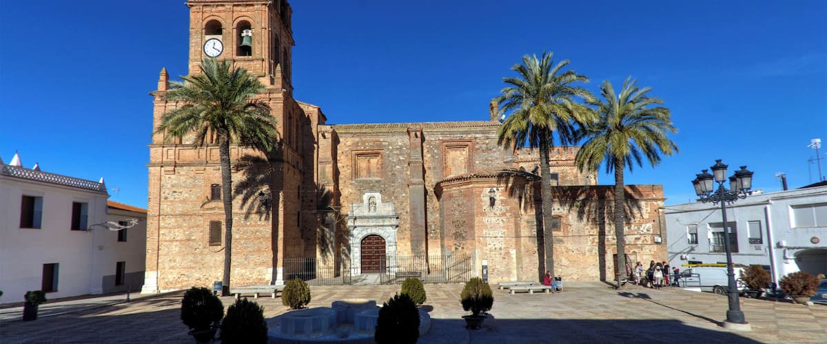 A historic church with a tall bell tower and a clear blue sky.