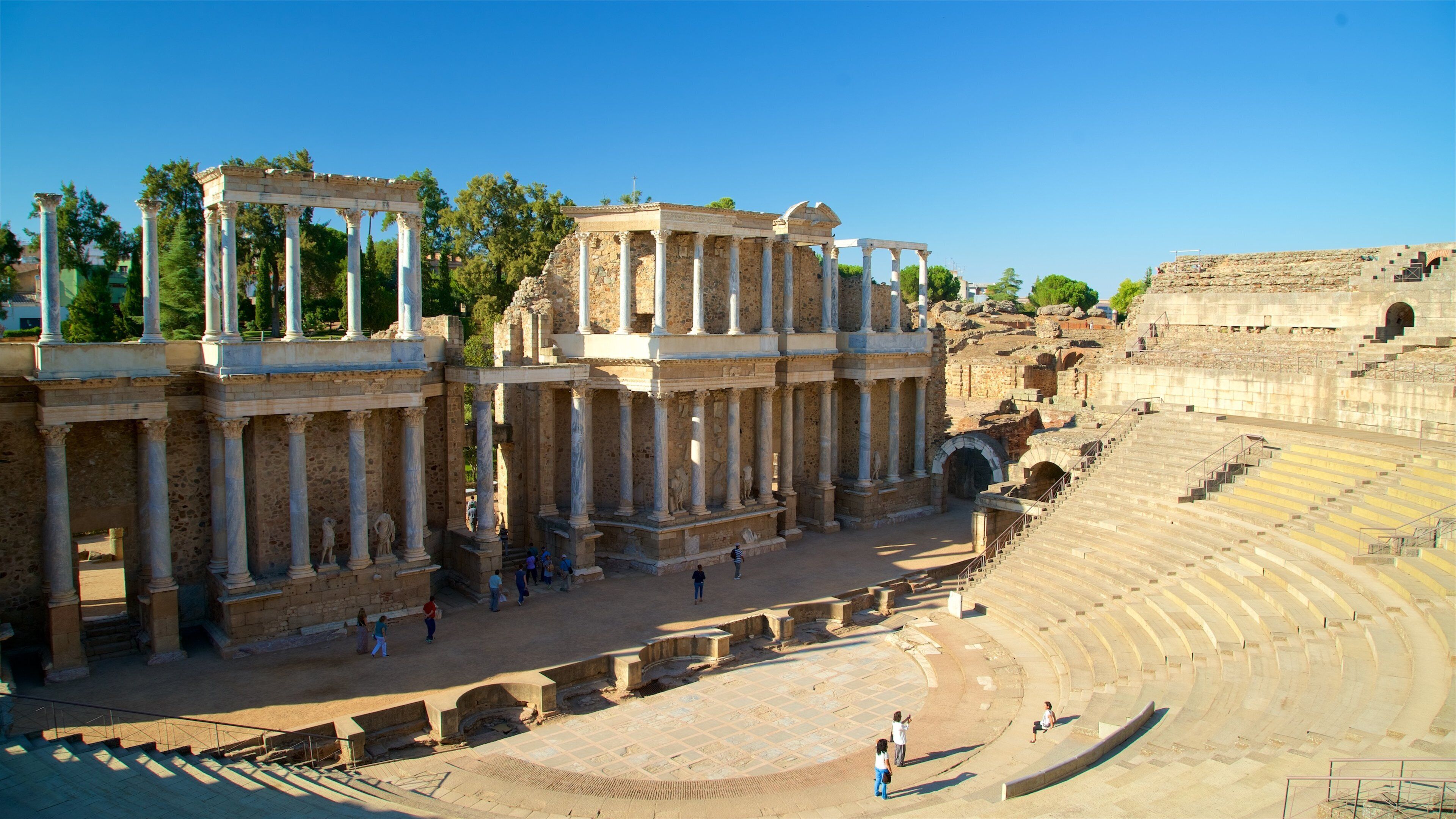 Ancient ruins with columns and an amphitheater.