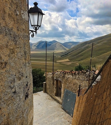 The drive to Castelluccio is itself famed and remarkable, but a visit to the small town at the end of the journey is a must (don't just turn around!)
It's a maze of twisty roads uphill, but taking the time to walk them means many hidden viewpoints to be discovered. It's quiet, very few tourists make it this far, and might even be worth a stay for a couple of days.