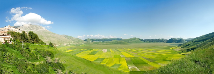 Ein Tal mit terrassenförmig angelegten Feldern und einem Berg im Hintergrund.