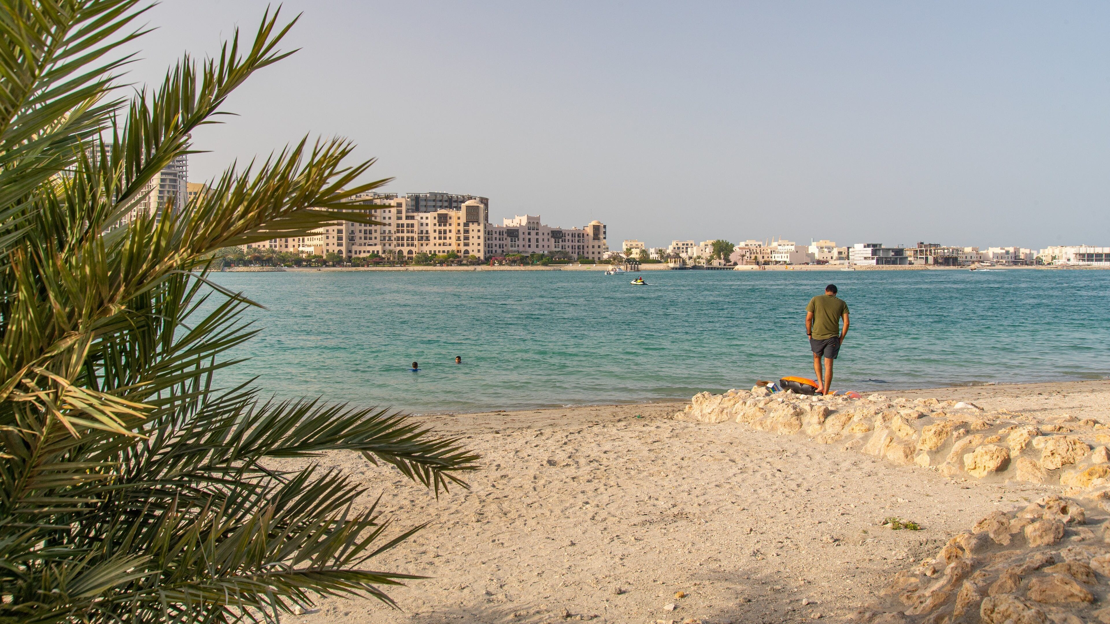 Amwaj Islands featuring general coastal views and a beach as well as an individual male