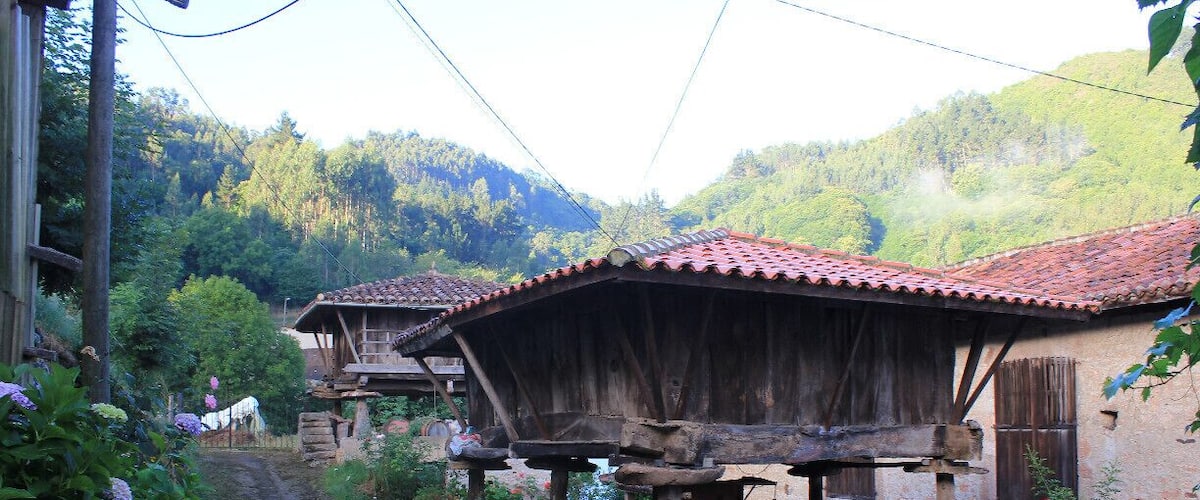 A rustic village with wooden houses and a dirt road.