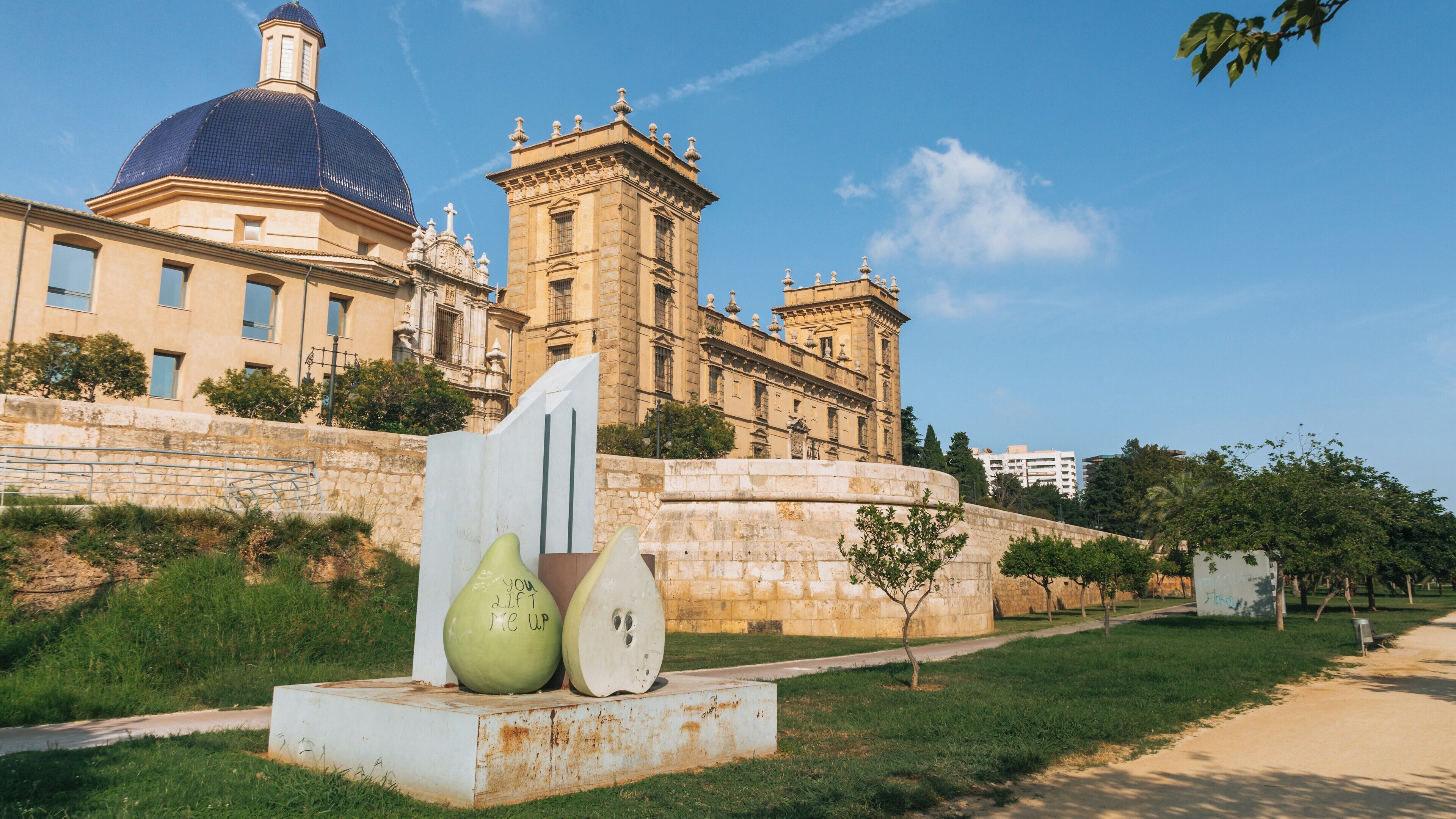 Strolling through Turia Gardens featuring unique sculptures in Valencia City Centre under clear blue skies
