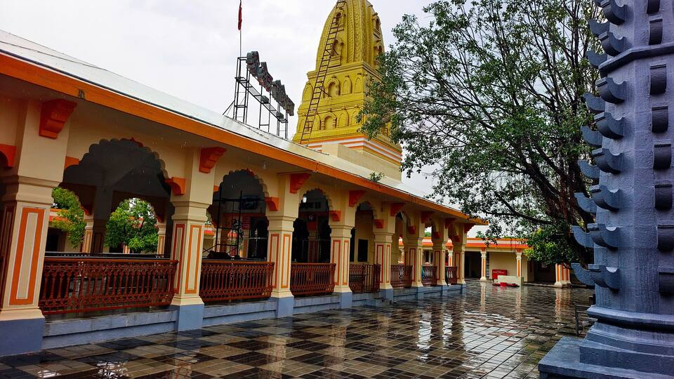 A temple with a yellow spire, a checkered floor, and a flag.