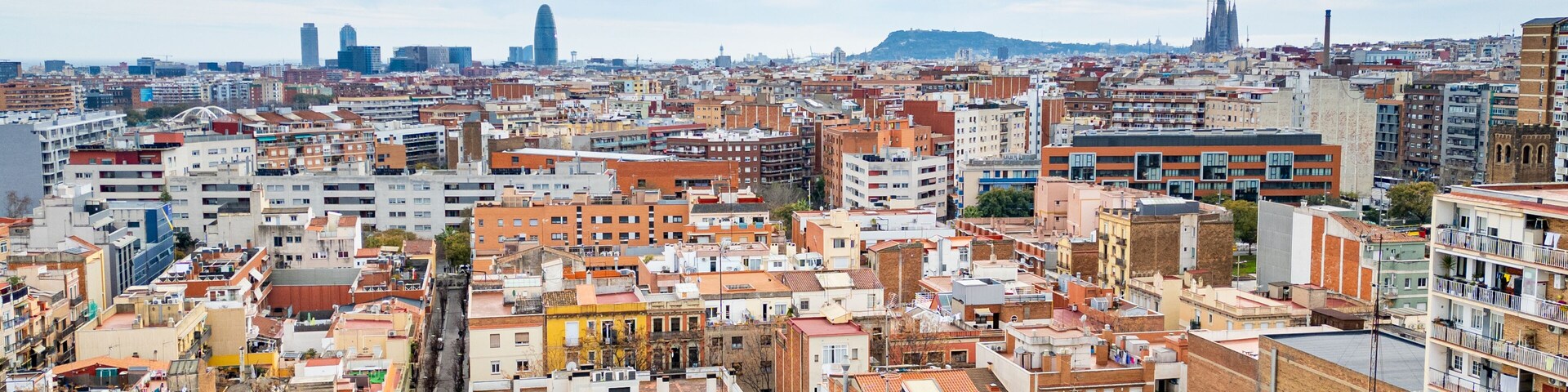 Aerial view of the Sant Andreu neighborhood in Barcelona with residential buildings and streets. Concept of housing crisis in Spain