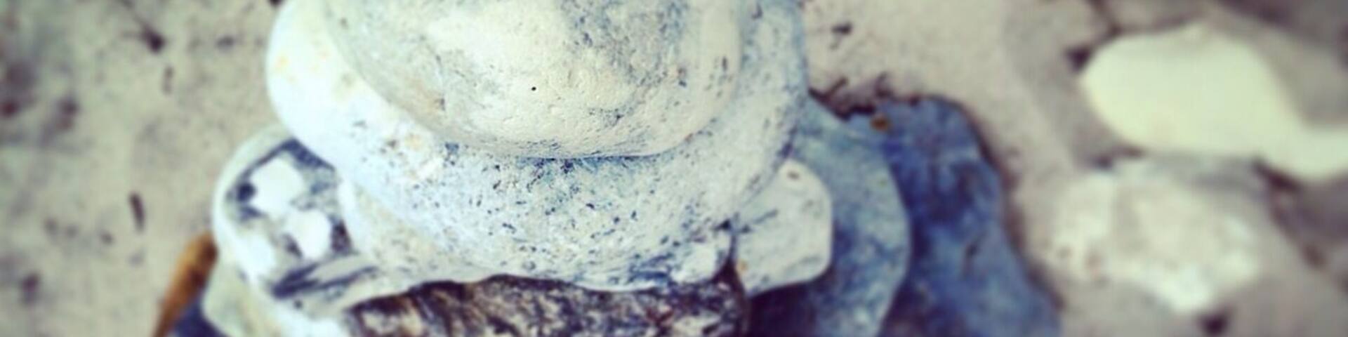 Pile of rounded beach rocks.
Real nice, often empty, small beach area.
My dad's been coming here since childhood, and I have too..