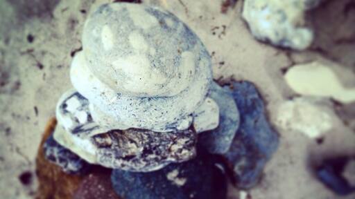 Pile of rounded beach rocks.
Real nice, often empty, small beach area.
My dad's been coming here since childhood, and I have too..