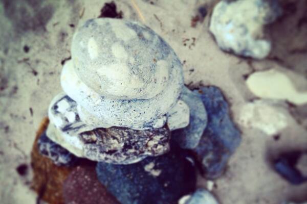 Pile of rounded beach rocks.
Real nice, often empty, small beach area.
My dad's been coming here since childhood, and I have too..