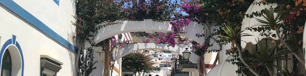 Small fishing village 15 Euro taxi ride or boat ride from Puerto Rico - lovely place for a harbour lunch, quaint old town, nice little beach with plenty of water sports and a huge market held every Friday. Worthy of a visit :)