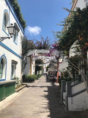 Small fishing village 15 Euro taxi ride or boat ride from Puerto Rico - lovely place for a harbour lunch, quaint old town, nice little beach with plenty of water sports and a huge market held every Friday. Worthy of a visit :)