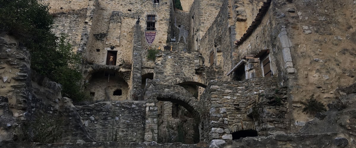 An ancient stone fortress with multiple towers and arched doorways.