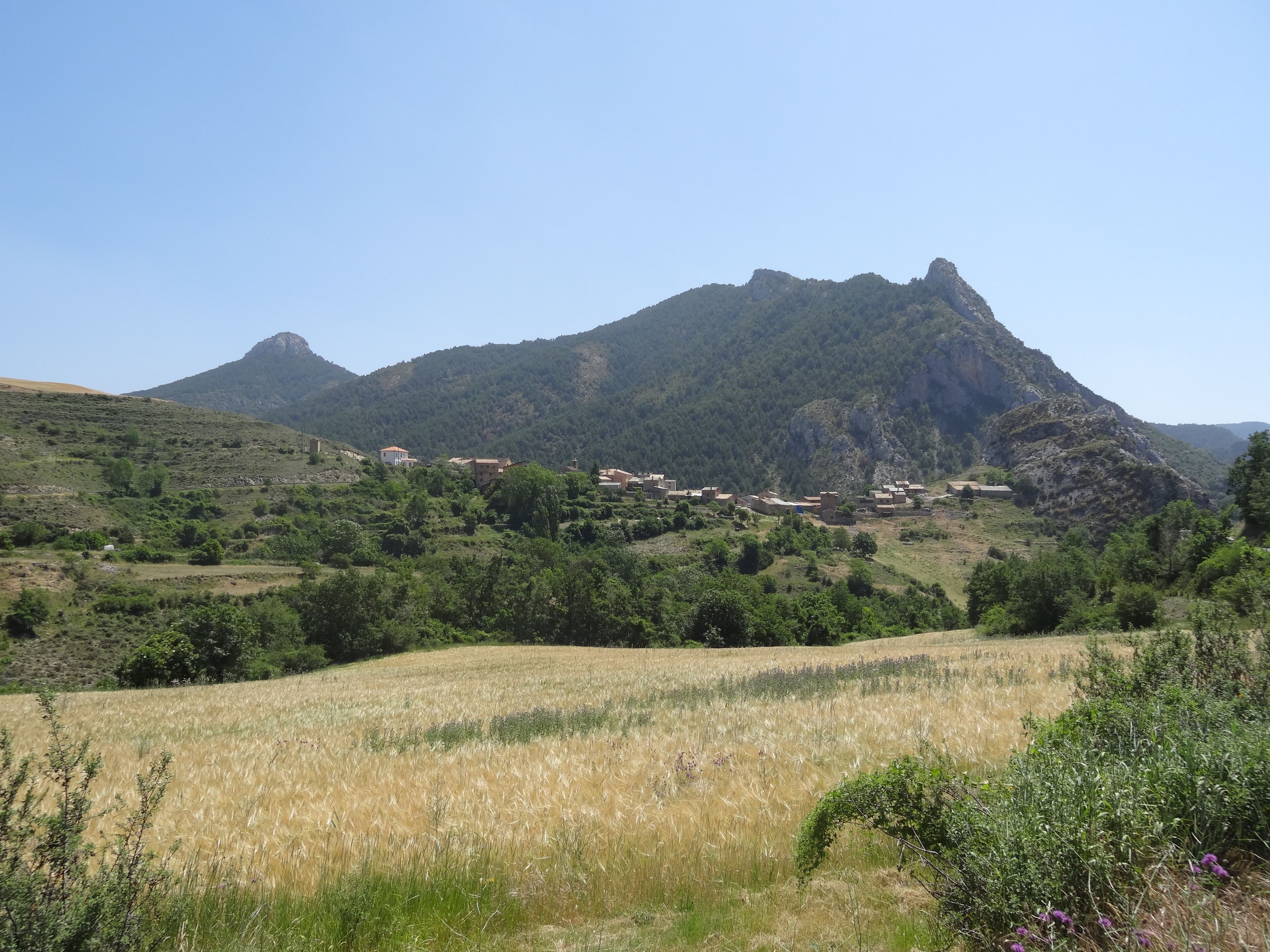 A mountainous landscape with a village nestled among the hills.