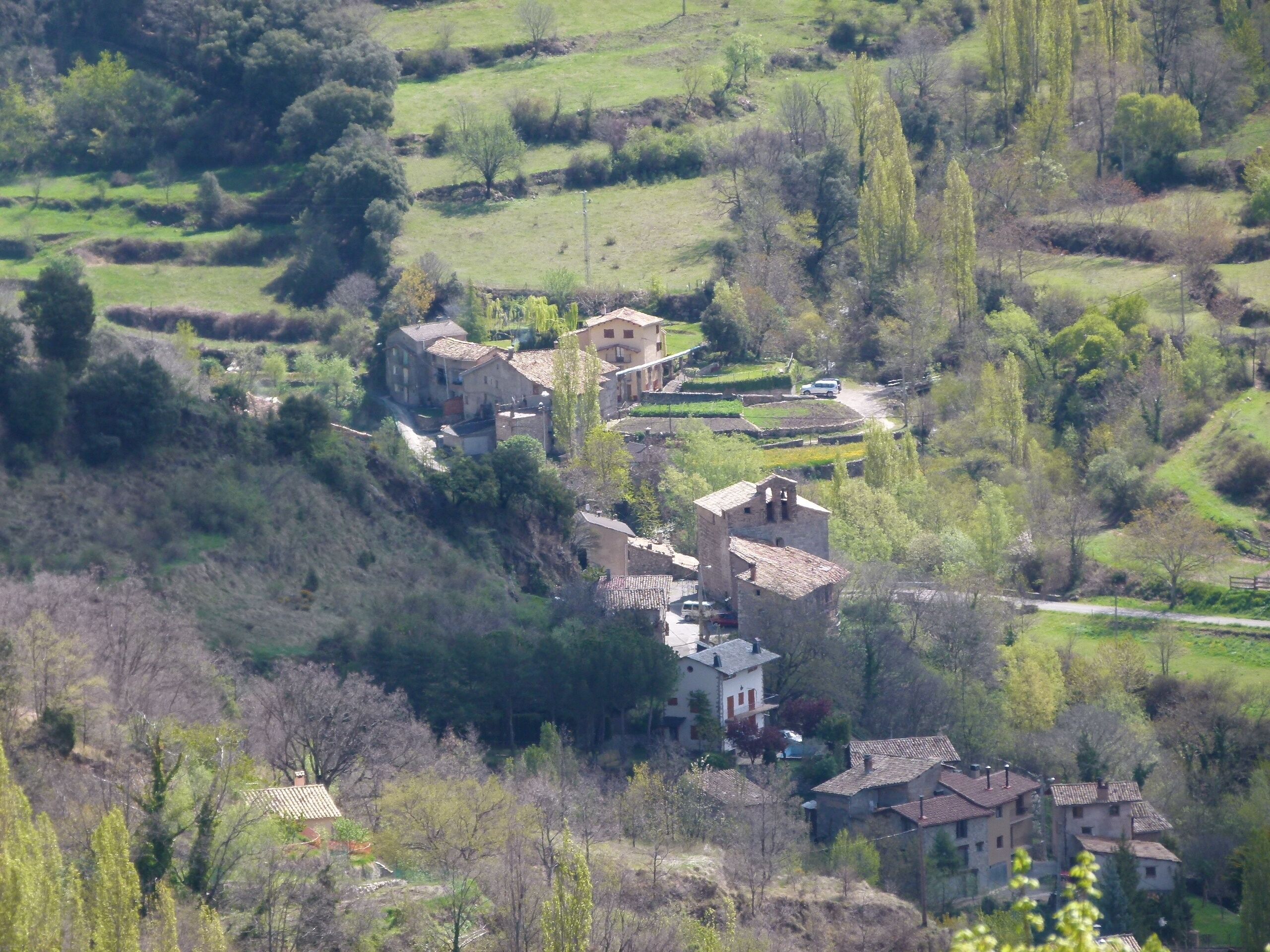 A rural village with terraced fields and traditional stone buildings.