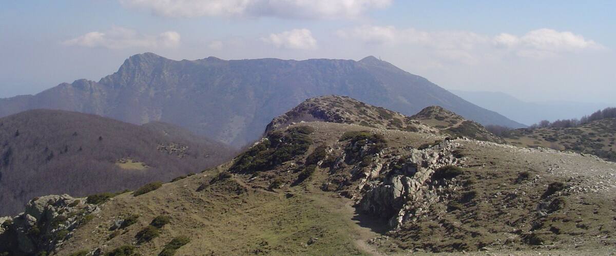 A mountainous landscape with rocky terrain and a clear sky.