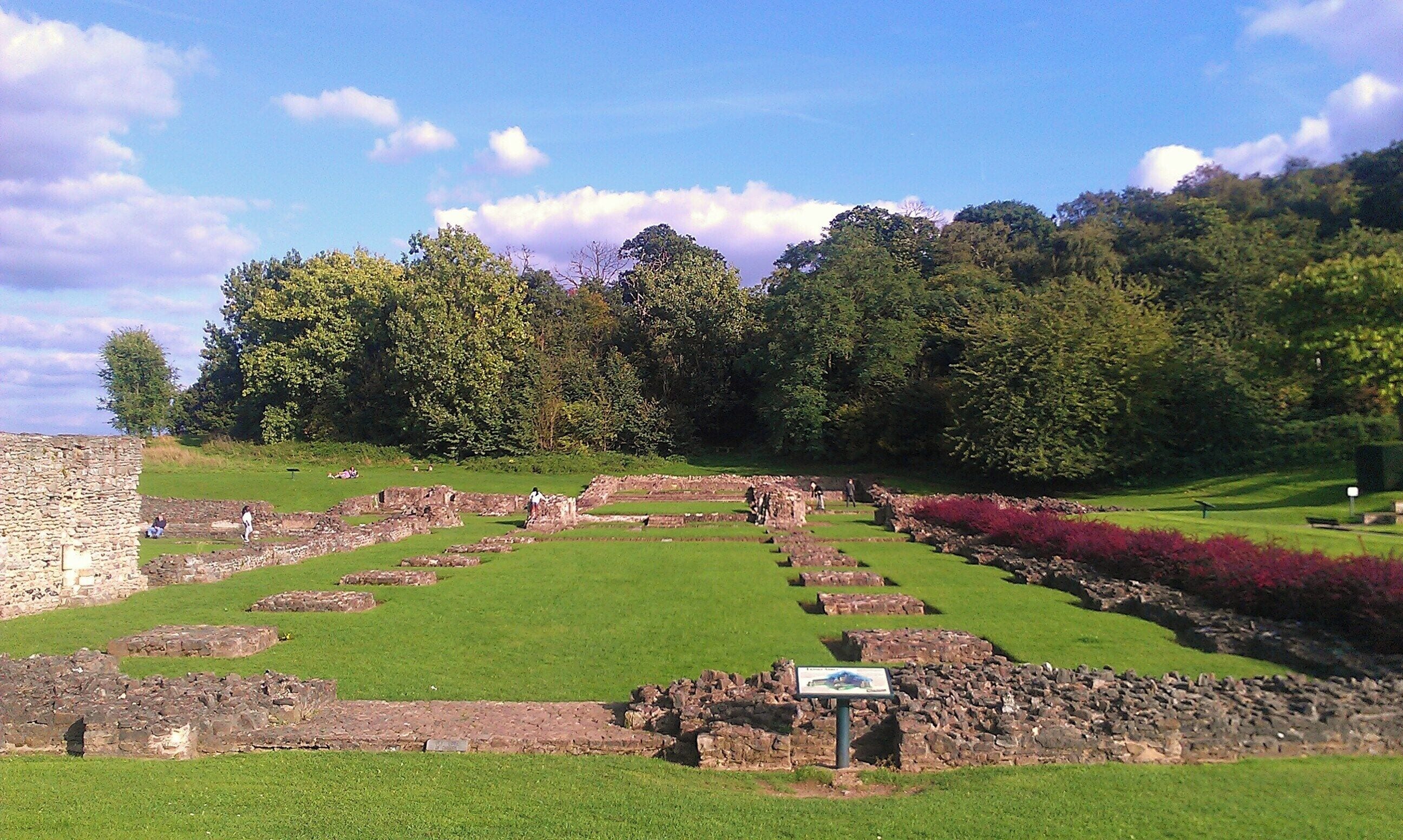 The remains of Lesnes Abbey in southeast London. Depicted here is the nave from its western end, facing east. Lesnes Abbey Wood is visible in the background.