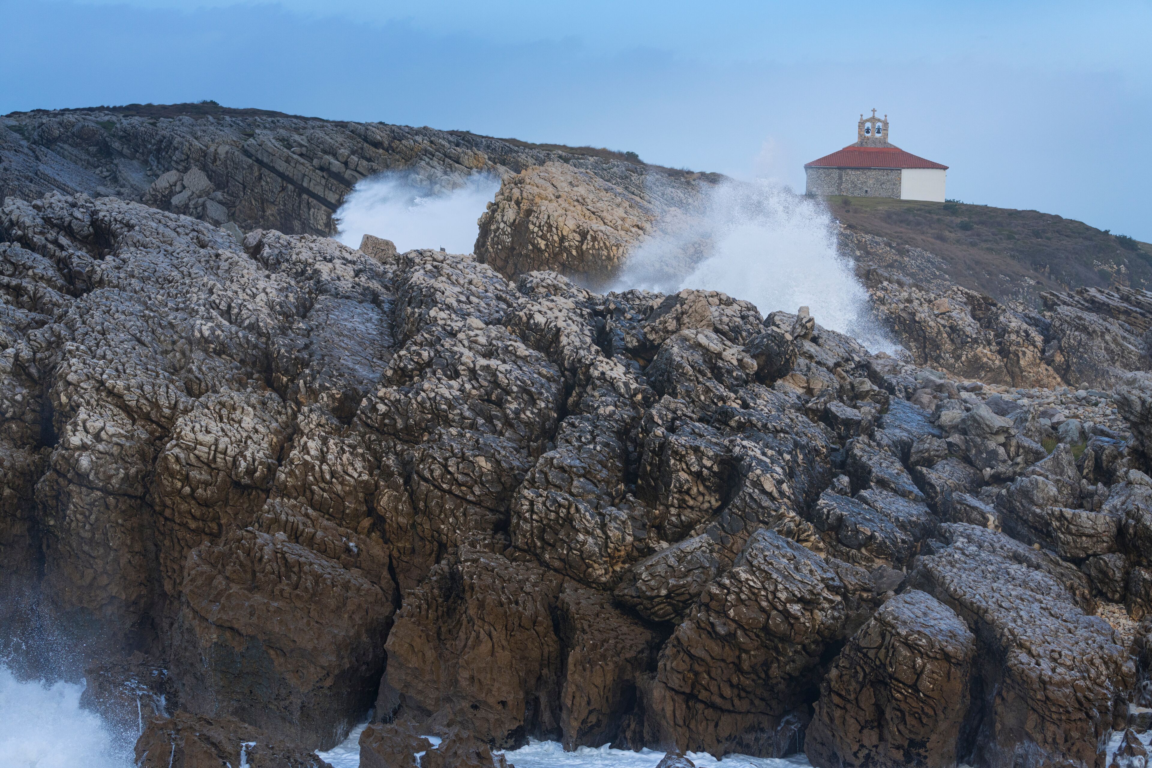 Swell and storm in the Hermitage of the Virgen del Mar in San Roman de la Llanilla in the Municipality of Santander. Cantabrian Sea. Autonomous Community of Cantabria. Spain. Europe