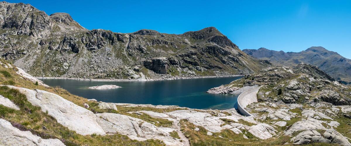 A mountain lake surrounded by rocky terrain and steep cliffs.