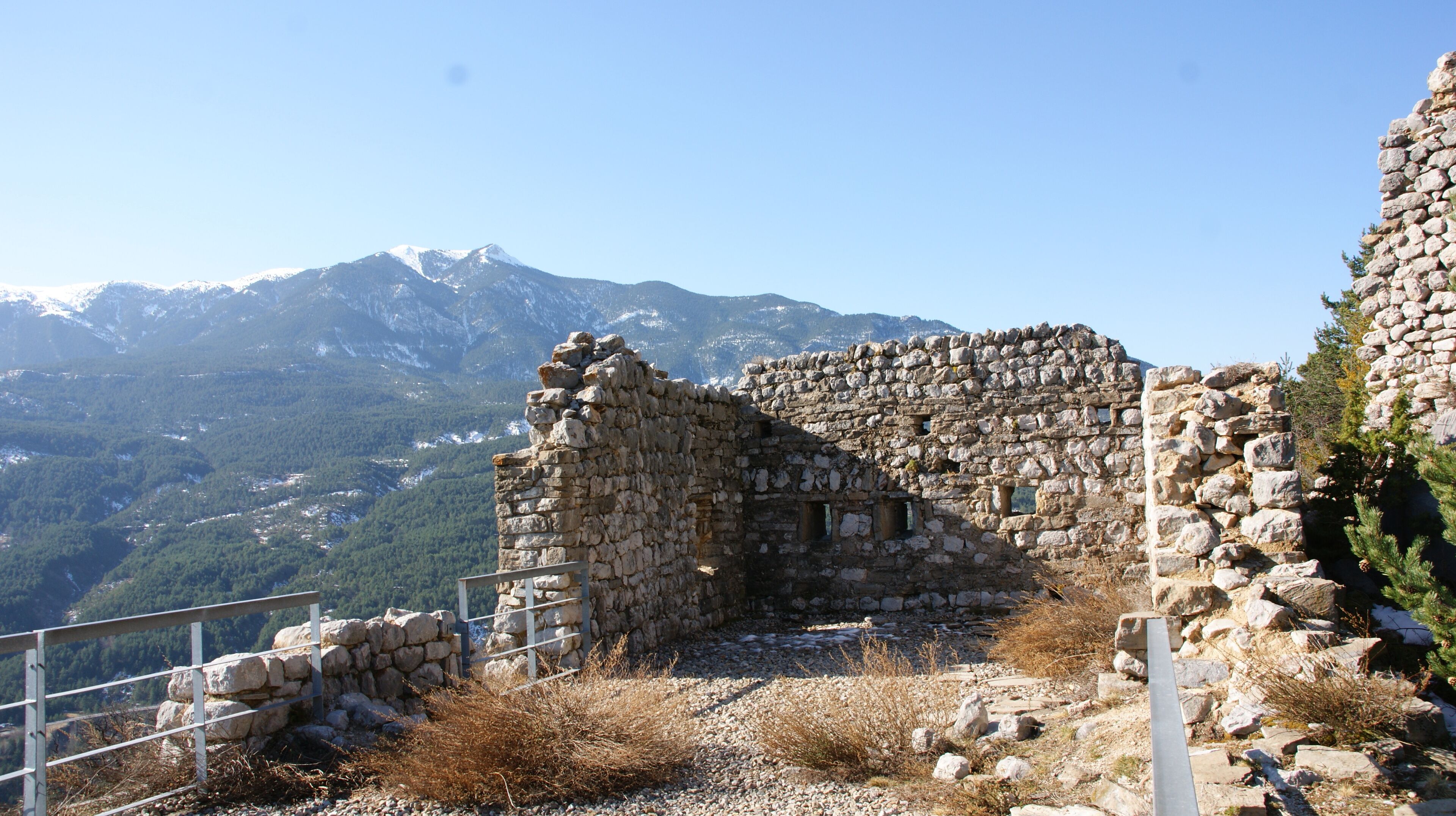 A stone ruin with a mountain backdrop.