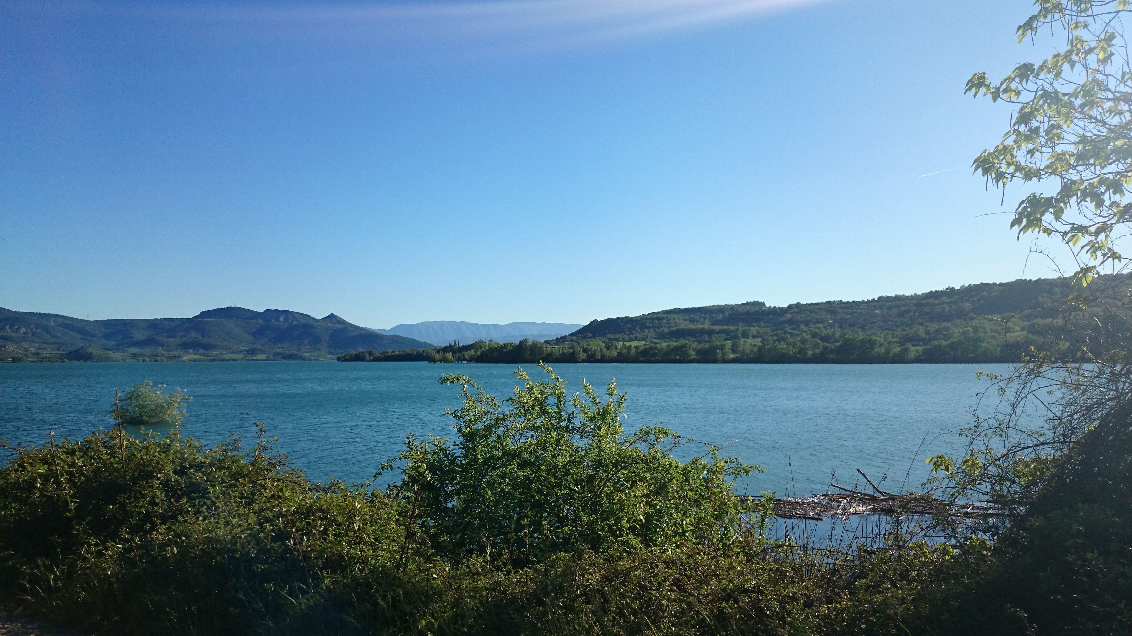 A lake surrounded by hills and trees.