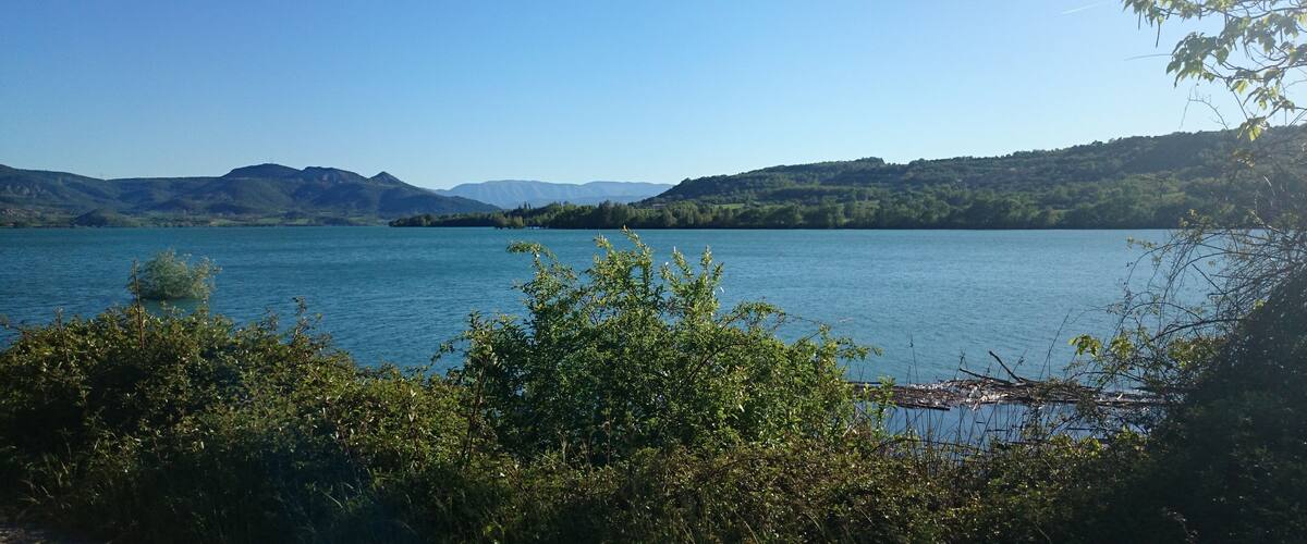 A lake surrounded by hills and trees.