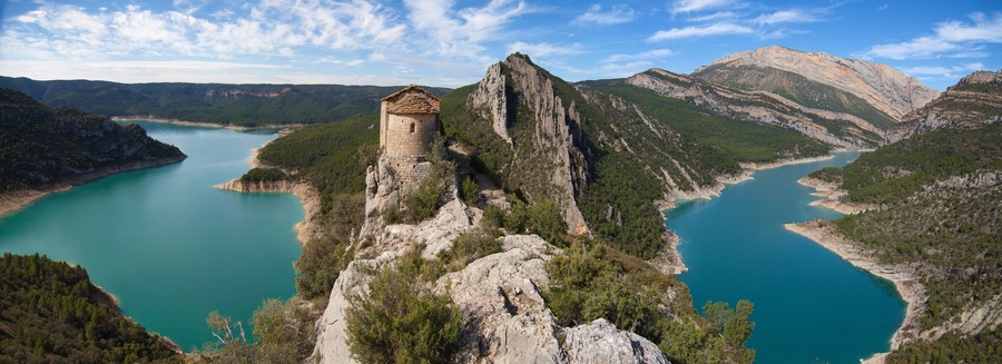 A coastal landscape with a prominent rocky outcrop and a small tower-like structure.