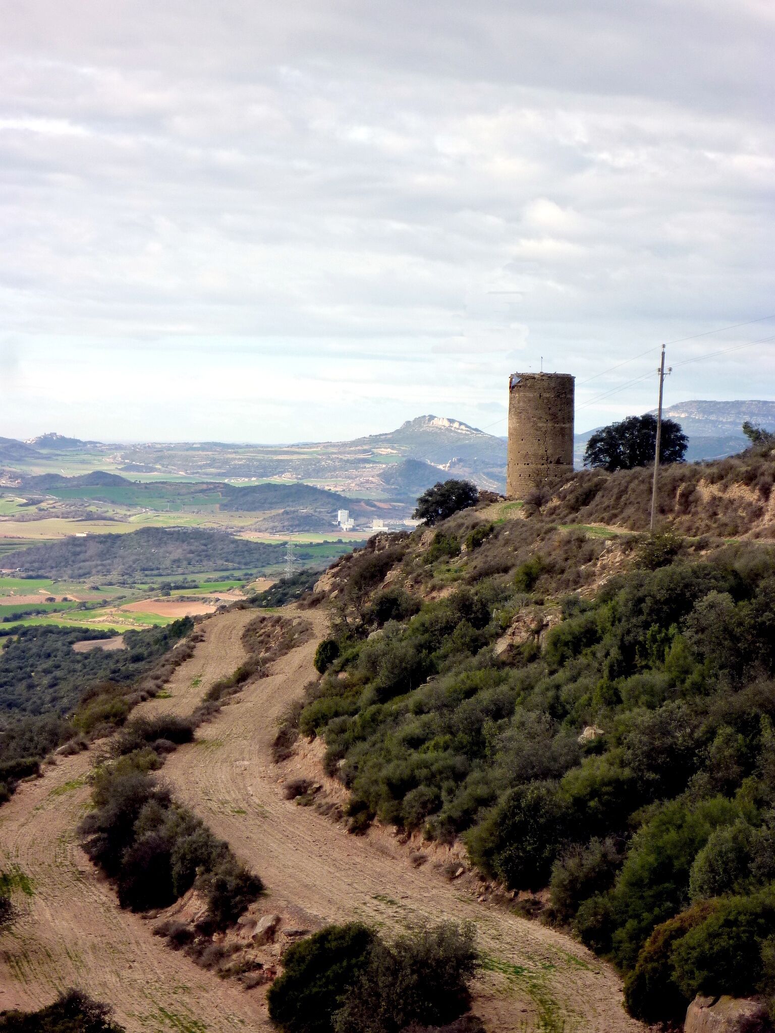 A hill with a tower and a winding path.