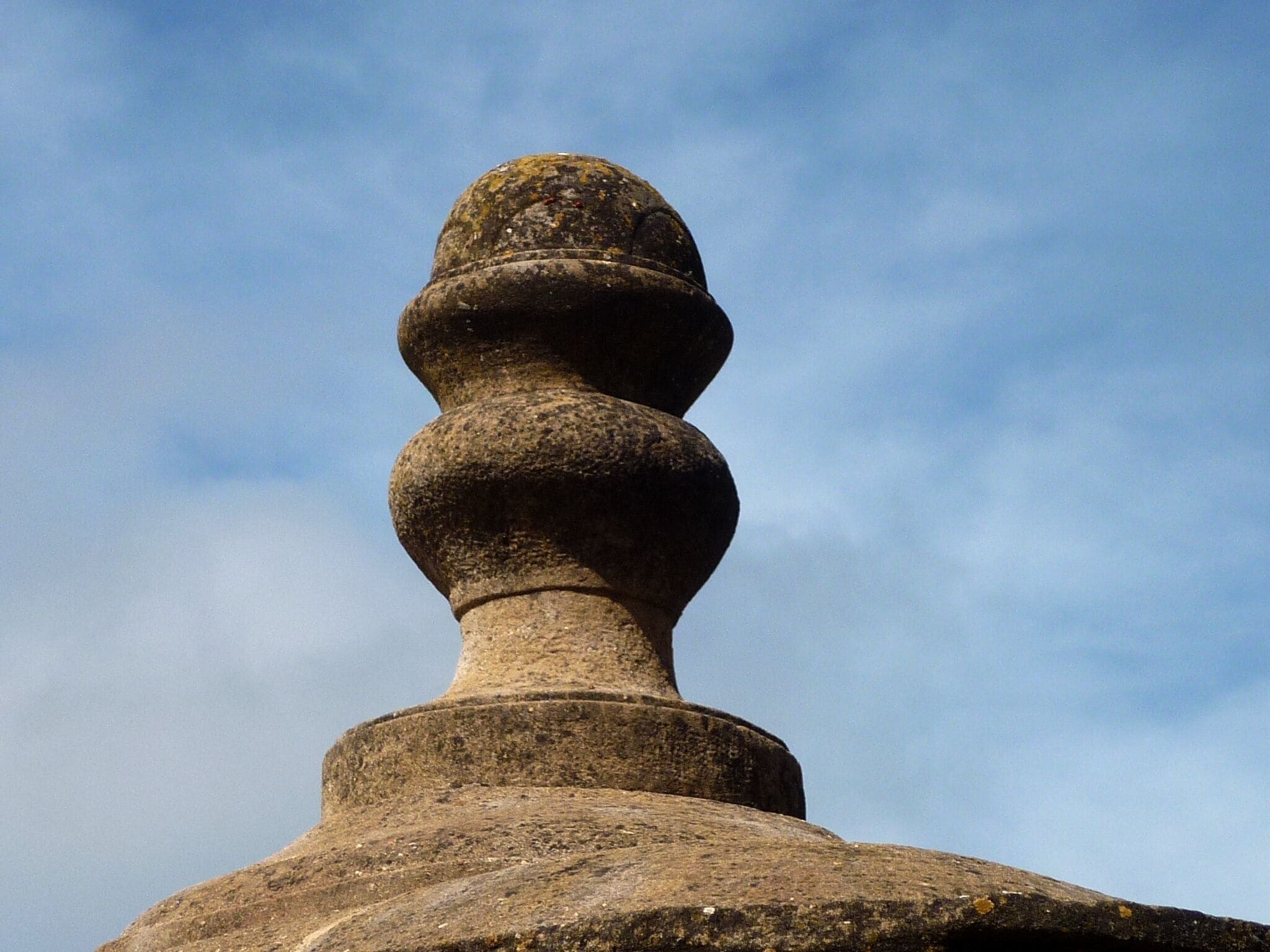 A stone structure with a rounded top and a cylindrical base.