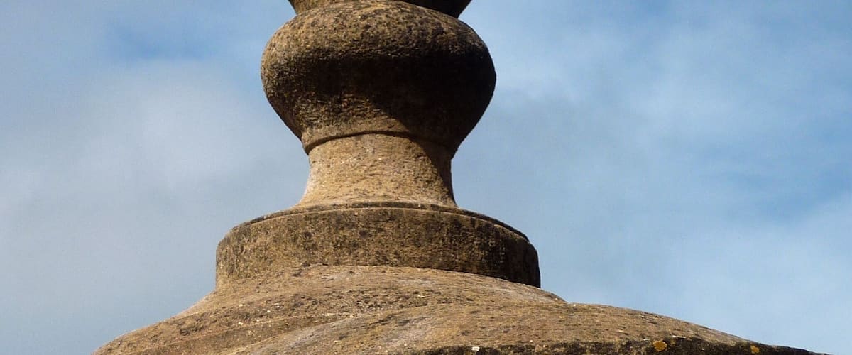 A stone structure with a rounded top and a cylindrical base.